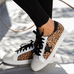 Kick Around In Our Dash Faux Suede Cheetah Sneakers! This Everyday Low-Top Sneaker Walks With An Eclectic Mix Of Cheetah Printed Faux Suede, A Grey Faux Suede Rounded Toe And White Leather Trim And Sole. Detailed With A Black Star Patch And Black Laces To Finish The Look. Styled With The Split Ankle Denim And The Highland Bag. Heel Height Approx. 1.25" Faux Suede Fabrication Faux Leather Trim Star Patch Gold Vent Holes Padded Foot Bed Rubber Soles Lace Up Closure True To Size Nwot Never Worn Siz Leopard Print Low-top Synthetic Sneakers, Trendy Leopard Print Lace-up Sneakers, Trendy Leopard Print Leather Sneakers, Leopard Print Lace-up Synthetic Sneakers, Fall Leopard Print Lace-up Sneakers, Cheetah Sneakers, Travel Sneakers, Black Wedge Sneakers, Round Toe Sneakers