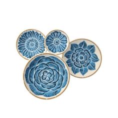 three blue and white plates sitting on top of each other, one with a flower in the center