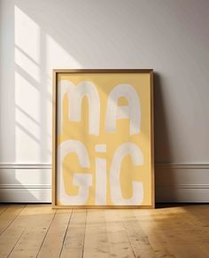 a yellow and white poster sitting on top of a hard wood floor