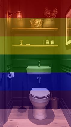 a bathroom with a toilet, sink and rainbow colored walls