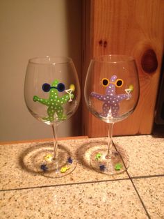 two wine glasses sitting on top of a counter