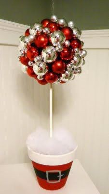 a cup filled with christmas decorations on top of a table