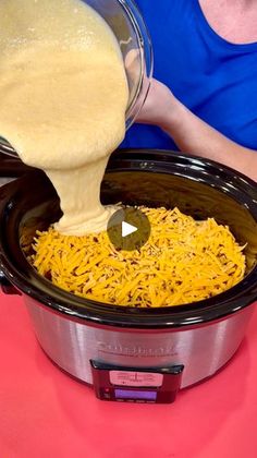 someone pouring cheese into a slow cooker