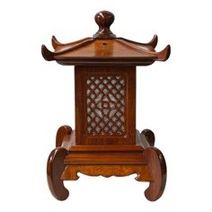 an antique wooden table with carved carvings on the top and sides, sitting against a white background