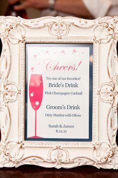 a white frame with a pink wine glass on it and the words cheers written in red