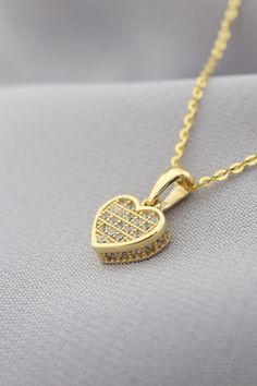 Adorn yourself with elegance and love with our enchanting Gold Heart Pendant Necklace. This dazzling piece features intricate details and sparkling stones that capture the essence of romance and charm. The heart-shaped pendant exudes a sense of sentiment and beauty, making it a perfect accessory to express your affection for someone special. Whether it's a gift for yourself or a loved one, this necklace is an ideal choice to celebrate love and emotions. Embrace the magic of this pendant as it sh Valentine's Day Cubic Zirconia Heart Necklace, Heart-shaped Jewelry With Sparkling Stones For Gifts, Diamond Heart Charm Necklace For Valentine's Day, Heart Pendant Jewelry With Sparkling Stones For Gifts, Gift Heart Pendant Jewelry With Sparkling Stones, Heart-shaped Sparkling Stones Jewelry For Valentine's Day, Diamond Necklace For Valentine's Day Gift, Valentine's Day Diamond Heart Necklace With Charm, Valentine's Day Double Heart Jewelry With Sparkling Stones