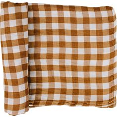 two brown and white checkered pillows sitting next to each other on a white background