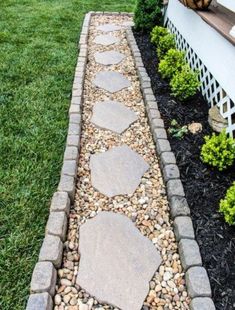 a stone path in the middle of a yard