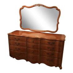 an old dresser with a mirror on top and drawers below it, against a white background