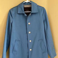 New Coach Women's Trench Coat. Size Xs. Light Blue Color. Classic Blue Outerwear With Hidden Button Closure, Blue Casual Outerwear With Hidden Button Closure, Casual Blue Outerwear With Hidden Button Closure, Blue Peacoat With Hidden Buttons For Fall, Blue Peacoat With Hidden Button Closure For Fall, Blue Pea Coat With Buttons For Spring, Blue Fall Peacoat With Hidden Buttons, Classic Light Blue Long Sleeve Outerwear, Classic Blue Outerwear With Buttons