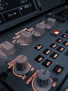 the control panel of an airplane with buttons and knobs