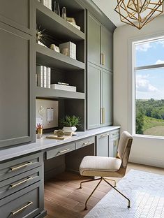 a home office with gray cabinets and gold accents