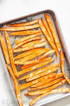 baked sweet potato wedges on a baking sheet ready to be cooked in the oven