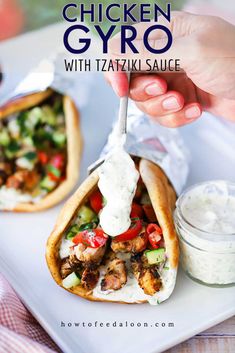 chicken gyro with tzatzka sauce is shown on a white plate