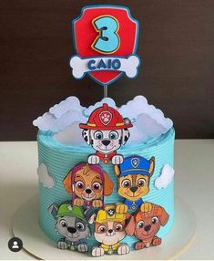 a birthday cake decorated with cartoon dogs and the number 3 on it's top