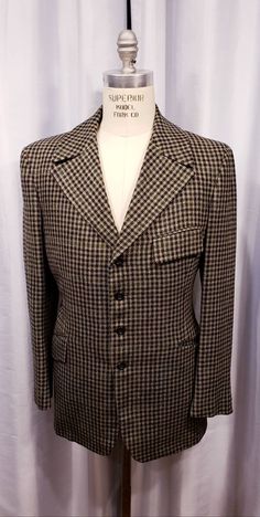 Beautiful houndstooth cloth two piece suit probably made in the 70's but exceptional quality. With the proper accessories it would be hard to tell this is not a true period piece, but the next best thing. Ready for the Dickens Faire or a period holiday party. Inside label reads: Mike Bain Inside pocket still has the Amalgamated Union Tag made in the USA the United States of America. Coat measures: Shoulders 18 1/2 inches, Chest 45 inches, sleeves 25 inches and length is 31 inches. Pants measure: Vintage Tweed Jacket With Welt Pockets For Office, Vintage Tweed Jacket For Office, Vintage Tweed Suit For Formal Occasions, Fitted Houndstooth Suits For Fall, Fitted Brown Houndstooth Blazer, Retro Plaid Formal Blazer, Retro Plaid Blazer For Formal Occasions, Retro Notch Lapel Tweed Jacket For Formal Occasions, Retro Tweed Jacket With Notch Lapel For Formal Occasions