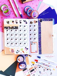 the contents of a planner spread out on top of a table with pens, scissors and other items