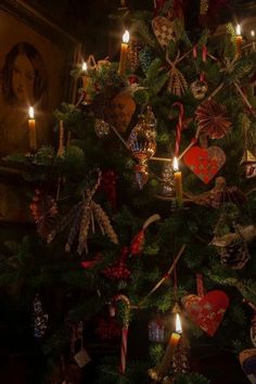 a christmas tree decorated with ornaments and candles