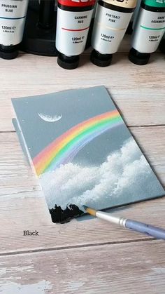 the paint is being used to create this rainbow painting on canvas with acrylic paints