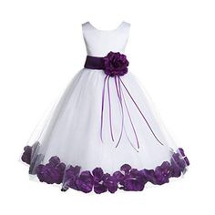 a white dress with purple flowers on the waist