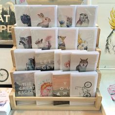 there are many cards on display in the store, including one with animals and birds