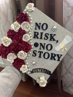 a graduation cap with flowers on it and the words, no risk, no story