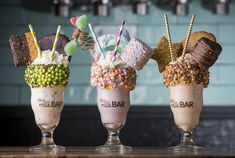 three glasses filled with different types of ice cream and toppings on top of each other