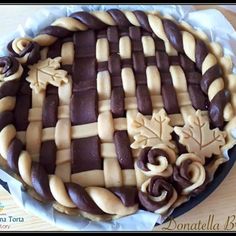 a pie with chocolate icing and decorations on it