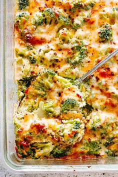 a casserole dish with broccoli and cheese in it on a pink background