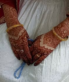 a woman's hands with hennap and bracelets