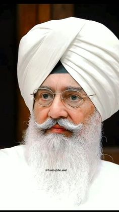 an old man with a white turban and glasses