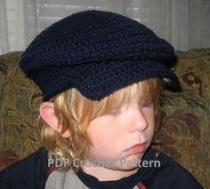 a young boy wearing a blue hat on top of a couch