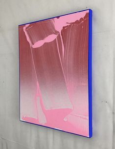 a pink and blue painting hanging on the wall