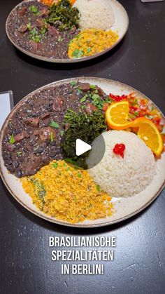 two plates filled with different types of food on top of a black table next to each other