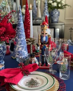 a christmas table setting with red, white and blue decorations