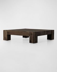 a wooden coffee table sitting on top of a white floor