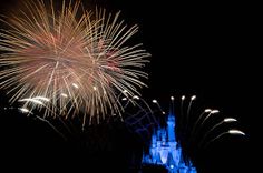 fireworks are lit up in the sky above a castle at disney's magic kingdom