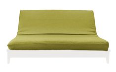 a green couch that is sitting on a white surface