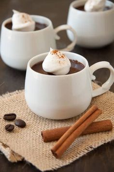 two mugs filled with hot chocolate and whipped cream