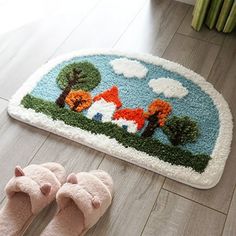 a pair of slippers sitting on top of a wooden floor next to a rug