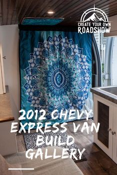 a blue and white quilt hanging from the ceiling in a kitchen