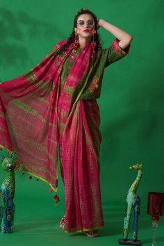 Green, magenta blouse with tie dye floral embroidered motifs and sequin work.
Component: 1
Pattern: Tie Dye and Embroidery
Type Of Work: Thread, Sequin and Beads
Neckline: Round
Sleeve Type: Half
Fabric: Cotton Silk
Color: Green,Pink
Other Details: 
Tie dye at the cuffs
Closure: Back button
Note: Saree worn by the model is not for sale
Occasion: Puja - Aza Fashions Magenta Blouse, Green Thread, Embroidered Motifs, Beaded Neckline, Blouse For Women, Fashion App, Blouse Online, Green Blouse, Green Cotton