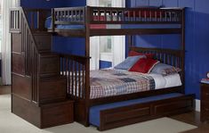 a bunk bed with drawers underneath it in a blue walled children's bedroom area