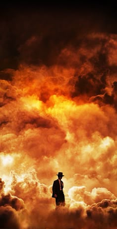 a man in a suit and hat standing on top of clouds