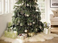 a decorated christmas tree in a living room with presents on the floor next to it