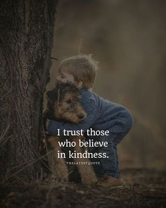 a little boy hugging a dog in front of a tree with the quote i trust those who believe in kindness