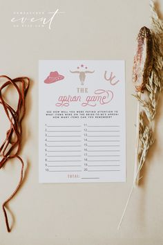 a baby word scramble board next to some dried flowers and twine on a table