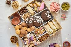 a box filled with lots of different types of cookies and desserts on top of a table