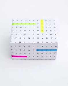 a white box with yellow and blue writing on the inside is covered in multicolored letters