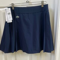 Navy Blue Tennis Skirt With Integrated Shorts Navy Casual Tennis Skirt, Navy Casual Pleated Skort, Casual Navy Pleated Skort, Navy Casual Pleated Skirt Skort, Navy Pleated Tennis Skirt, Navy Pleated Casual Skort, Navy Pleated Skort Casual Style, Navy Casual Pleated Skirt Bottoms, Navy Lined Tennis Skirt